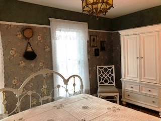 The gardenia wallpaper sets the mood for Victorian dreams in the Florence Myrna Room.